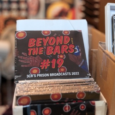 Photo of a collection of Beyond the Bars CDs next to a collection of magazines