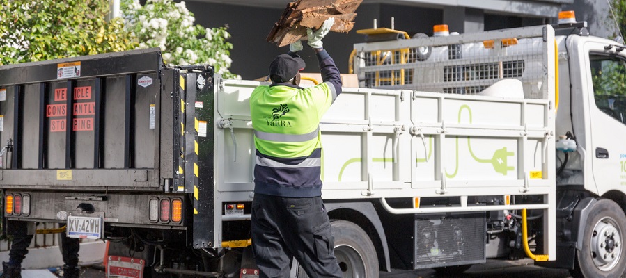 Man in Yarra City Council uniform loading a recycling truck