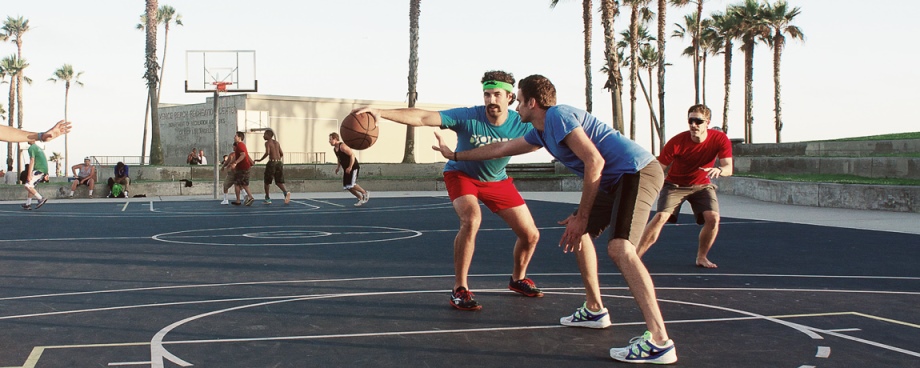 A group of people playing basketball