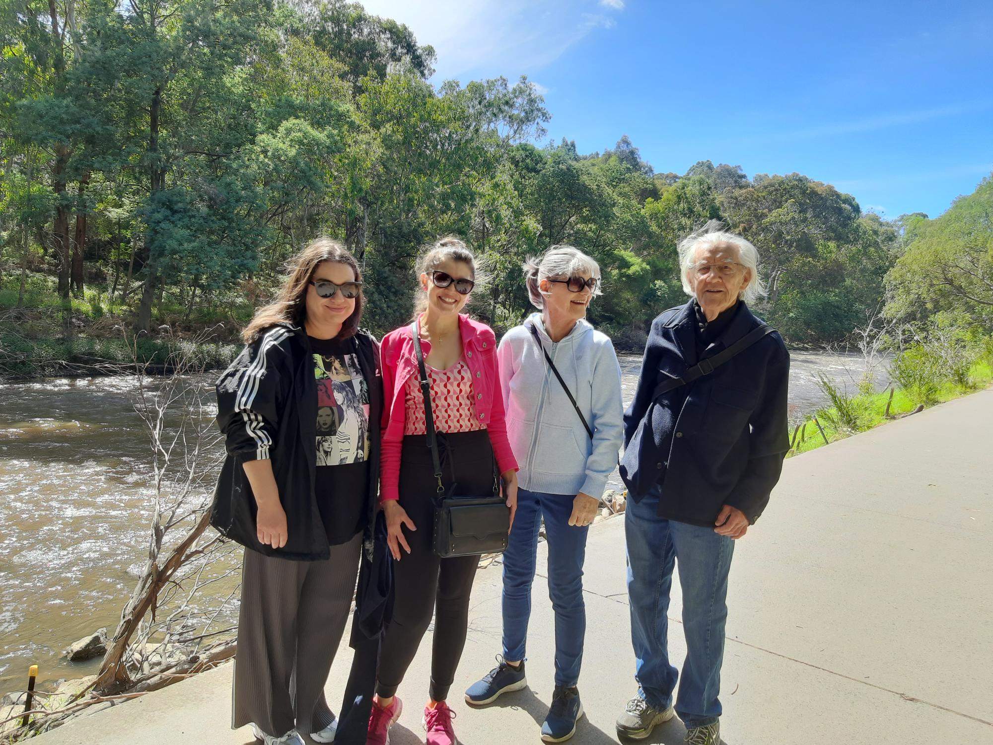 Four people standing by the Yarra