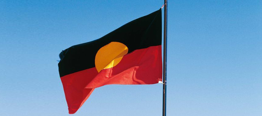 Picture of Aboriginal flag flying, with blue sky in background