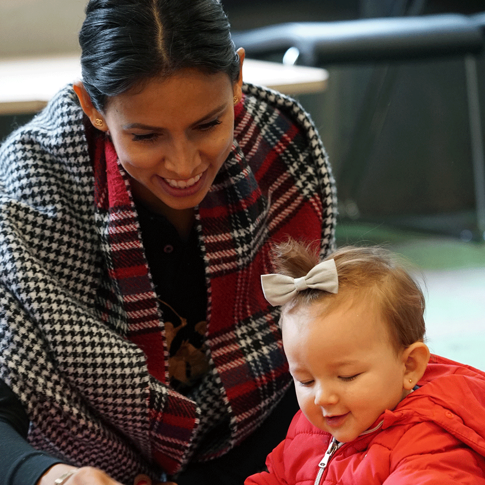 A woman and a child, both are smiling