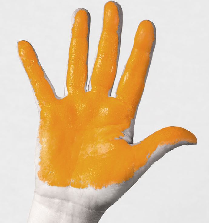 A hand held up with the palm painted with orange paint