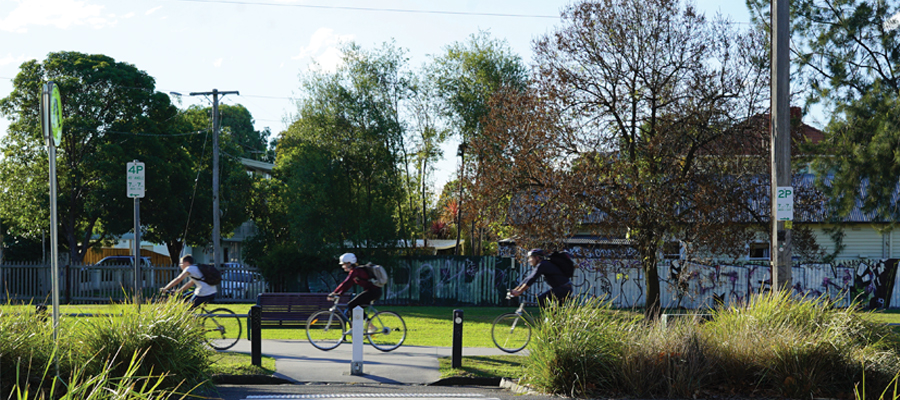 Cyclists riding along the Capital City Trail on Park Street, Carlton North