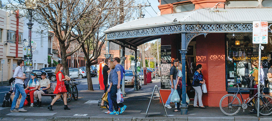 Image of people walking on a footpath outside a shop on Brunswick Street, Fitzroy