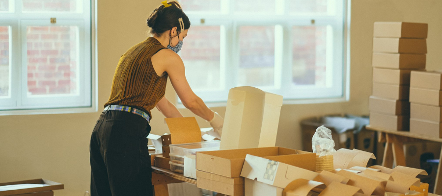 Woman packing gifts into boxes