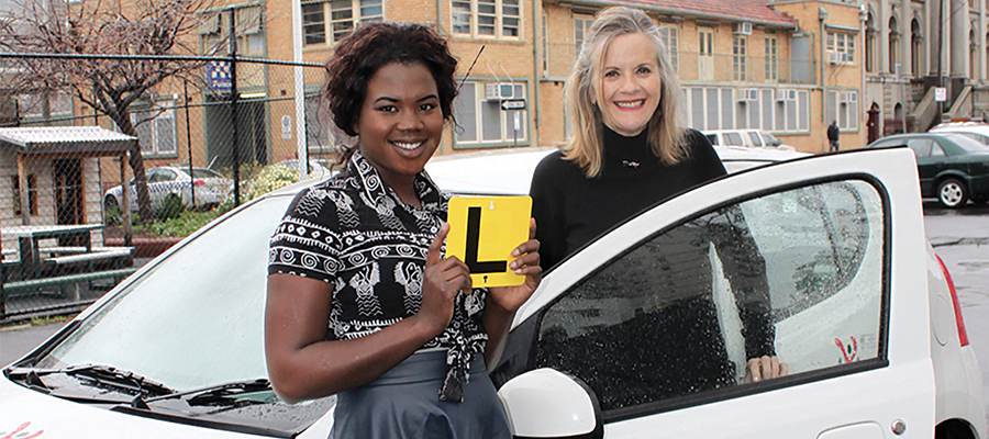 Learner driver and instructor with L2P Driving Program car with L-Plates