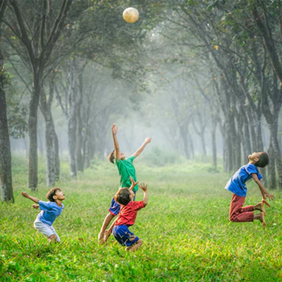 Group of children jumping up for a ball