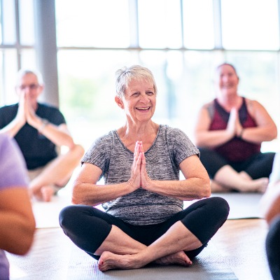 A group of older people in a yoga class