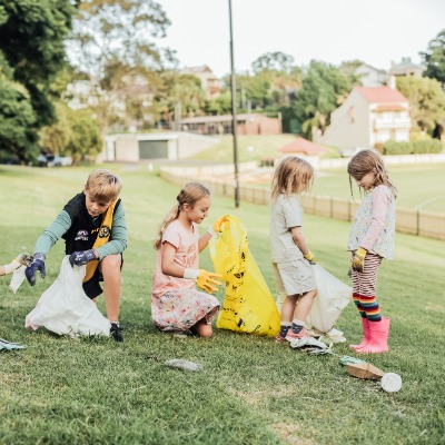 Group of children picking up rubbish in a park