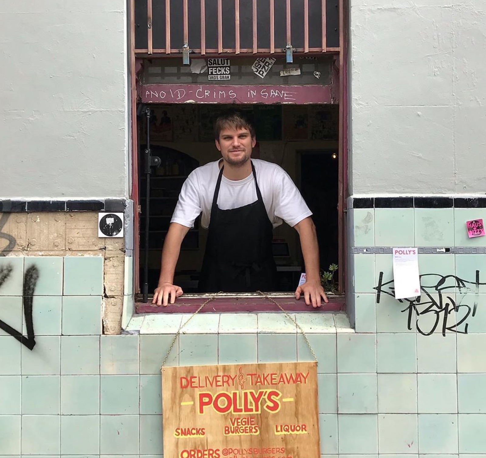 Image of takeaway burger restaurant Polly employee standing at the 'hole in the wall' window 