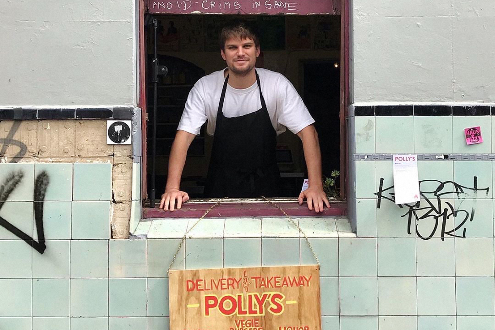 Image of takeaway burger restaurant Polly employee standing at the 'hole in the wall' window 