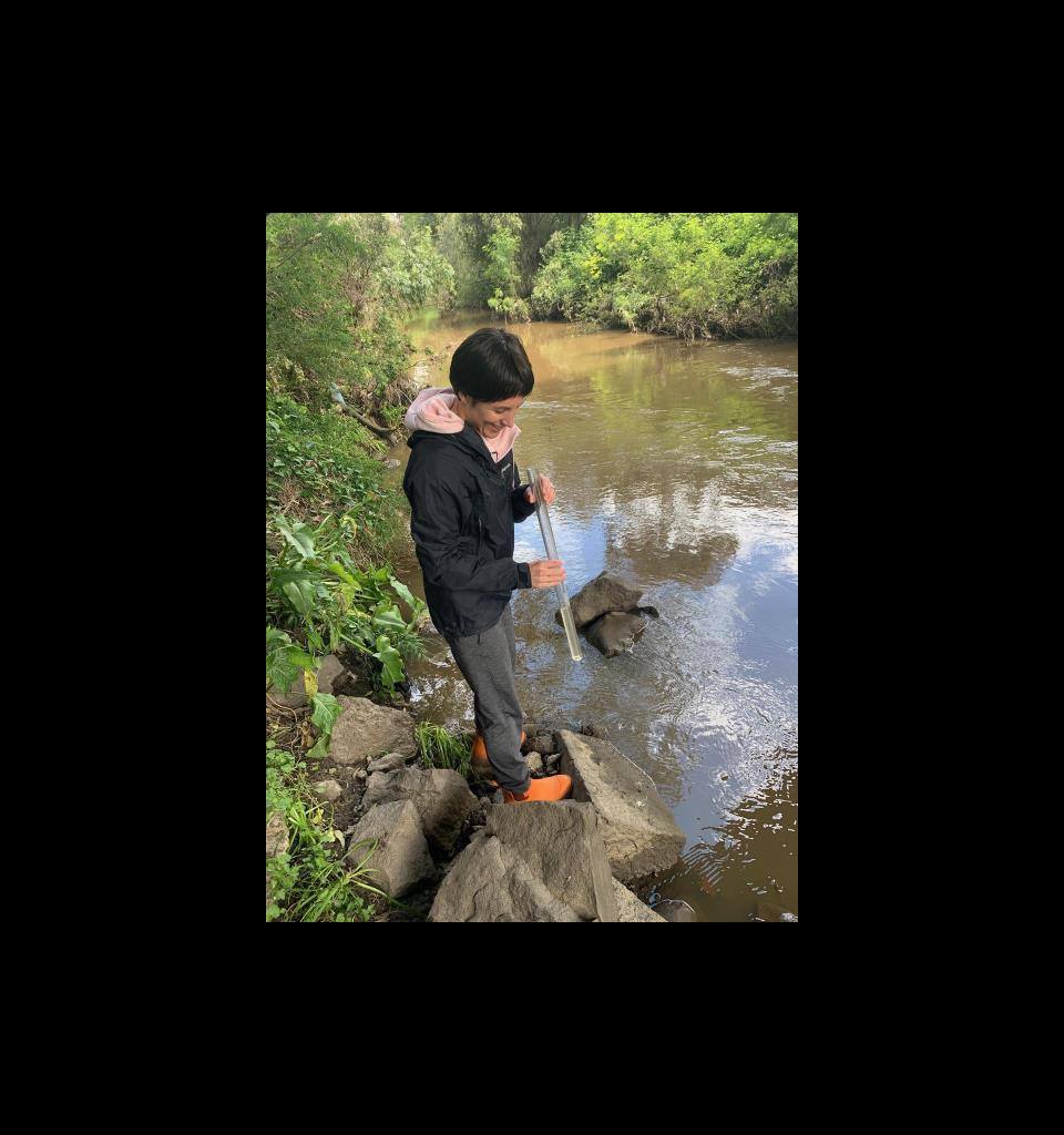 Woman testing water quality in creek