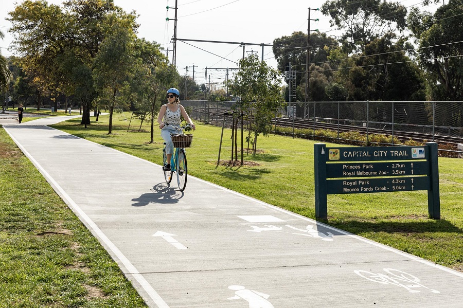 Woman riding a bike on the Capital City Trail in North Fitzroy.