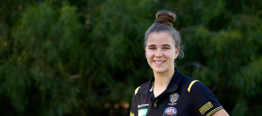 Woman smiling into camera wearing Richmond Australia Rules Football kit