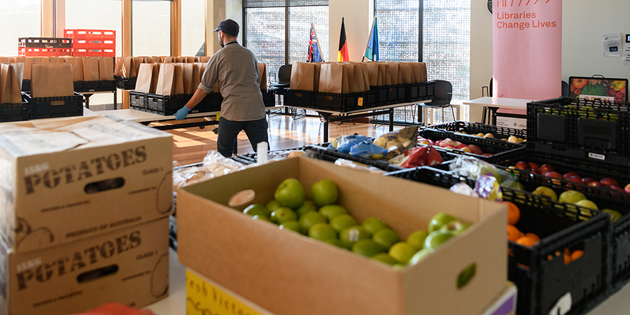 Food relief packages being prepared by Open Table including fresh fruit and vegetables in the foreground