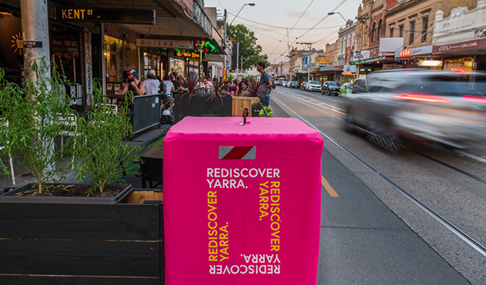 close up of rediscover yarra bollard near outdoor dining space