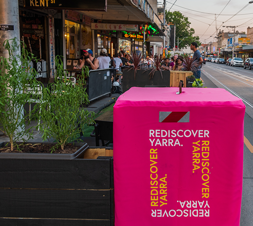 close up of rediscover yarra bollard near outdoor dining space