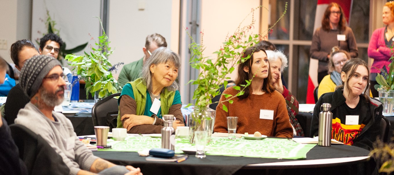 Community members listening at a climate action event