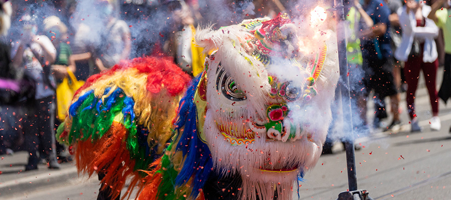 Lion dancer surrounded by confetti at Victoria Street Lunar New Year