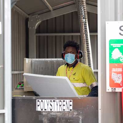 Yarra employee using polystyrene equipment for recycling
