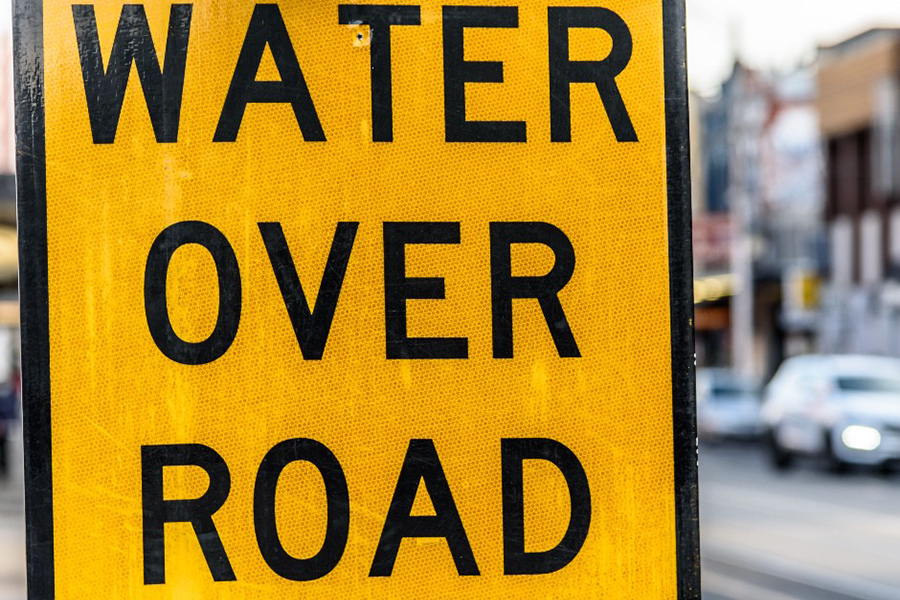 Water Over Road Yellow sign by the side of the road