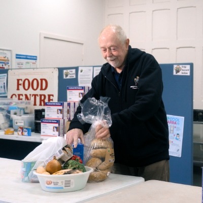 A volunteer packing food at Richmond Churches Food Centre