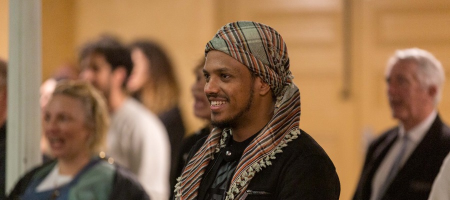 A person smiling in the audience at Yarra's citizenship ceremony 