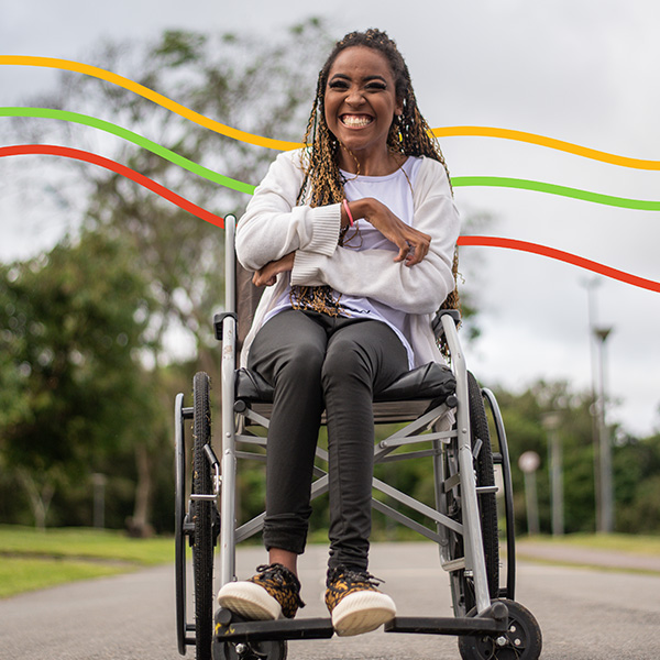 A young woman in a wheelchair at the park with decorative lines behind her