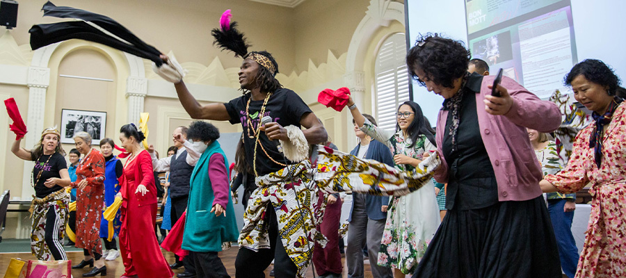 a group of people dancing at a Grants event at Richmond Town Hall