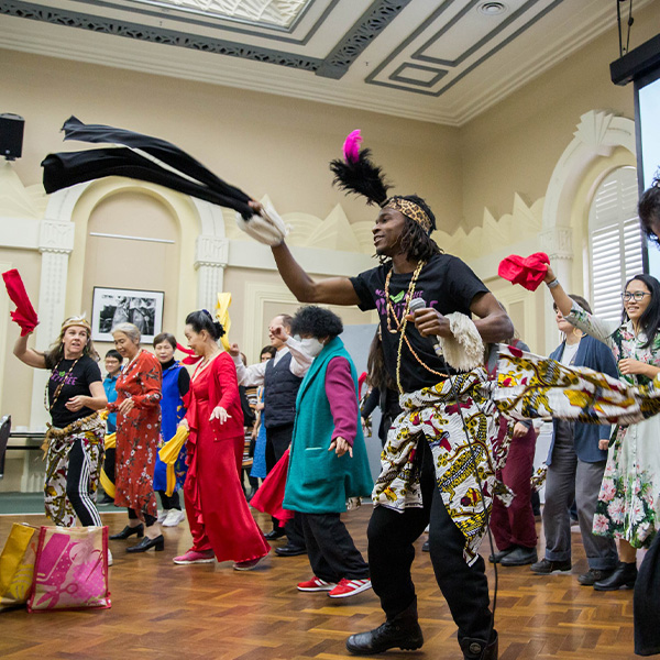 a group of people dancing at a Grants event at Richmond Town Hall