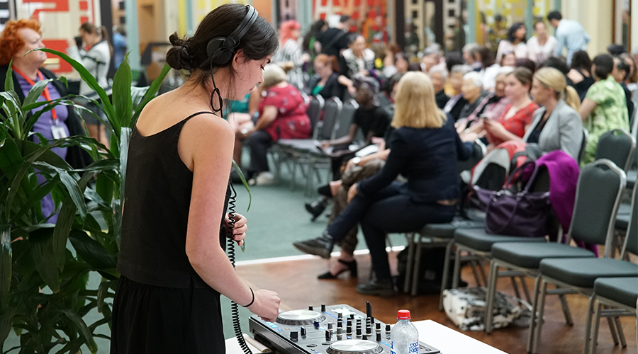 young lady djing at a community event 