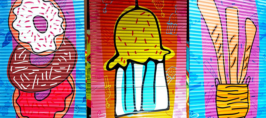 Colourful children's artwork of food on Victoria Street roller shutters