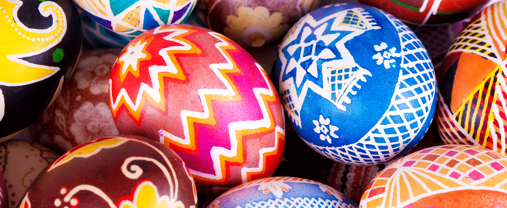 Eggs painted with bright patterns in red, orange, yellow and blue. 