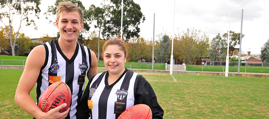 Male and female AFL players posing for photo