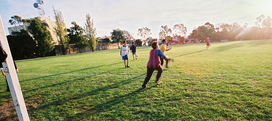 Children playing soccer on field