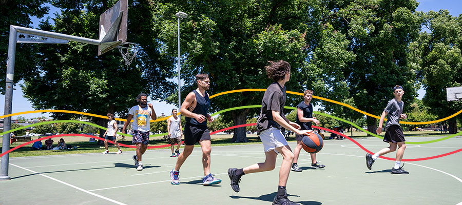 Basketball players mid-game at Edinburgh Gardens basketball court