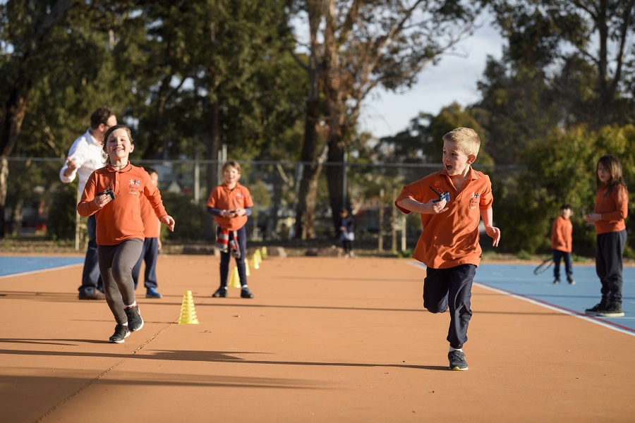 Science play - kids racing on an outdoor track