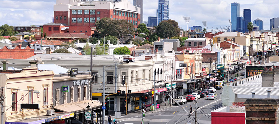 Bridge Road shops with Pelaco Building and Melbourne city skyline in distance