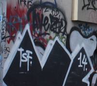 close up of graffiti tags on a wall