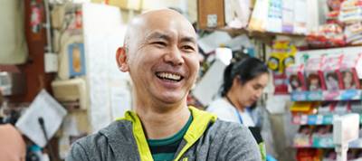 close up of man smiling in a shop