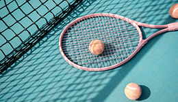 Tennis racket and balls on the ground of a tennis court