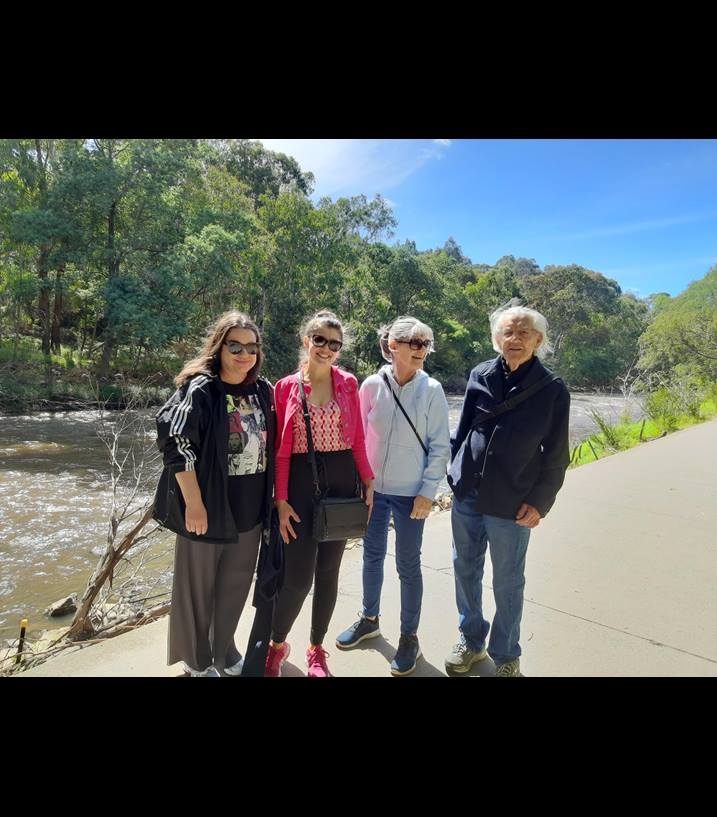 Four people standing by the Yarra