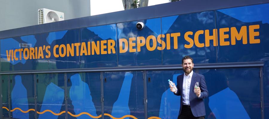 Mayor standing in front of a Container Deposit Scheme vending machine