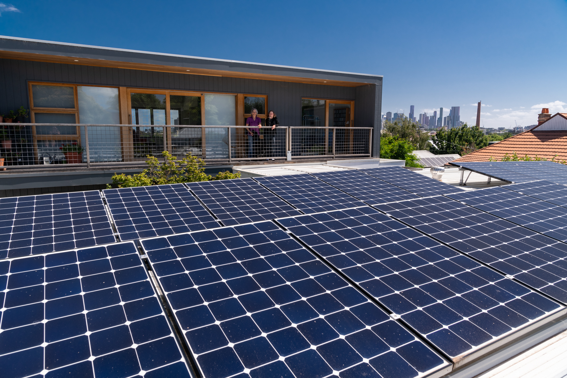 House with rooftop solar panels connected to the grid representing contact and site survey booking